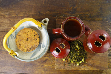Japan's teapot and cups with green tea on wooden plank
