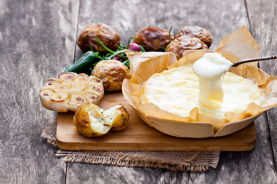 Delicious  baked camembert with roasted potato and garlic
