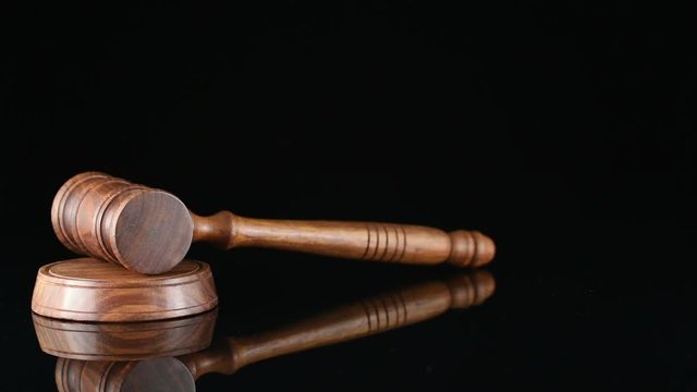 Judge. Referee hammer and a man in judicial robes