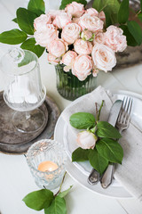 vintage wedding table decorations with roses, candles, cutlery a