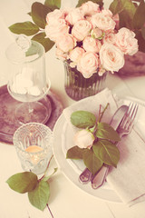 vintage wedding table decorations with roses, candles, cutlery a