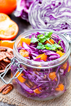 healthy  fresh salad with red cabbage and oranges with walnuts i