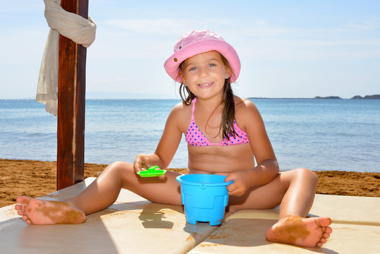 Adorable toddler girl enjoying her summer vacation at beach