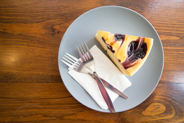 Blue berry cake slices in plate on wood table with to fork and n
