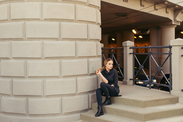 Woman sitting on the stairs with sunset