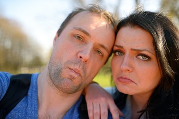 Fototapeta premium Portrait of young attractive couple having emotional fun tomfoolery together.