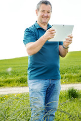 Man with tablet PC on the field