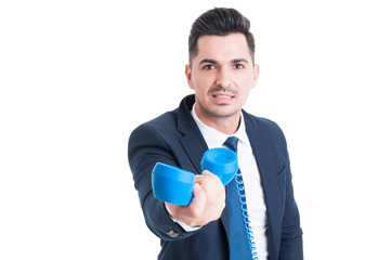 Portrait of attractive businessman holding retro telephone in hi
