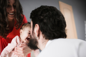 parents play with baby