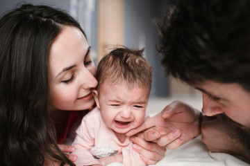mom, dad and daughter crying
