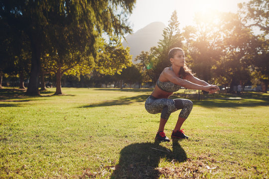 Young woman exercising in park on a nice summer day