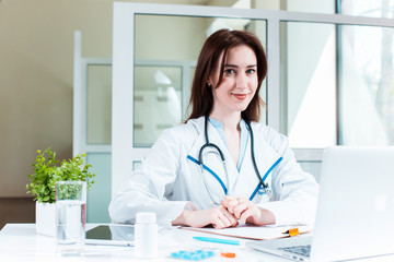 Woman doctor sitting at the table