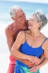 Cute mature couple embracing on the beach