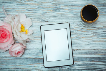 ebook and glass of red wine and flowers