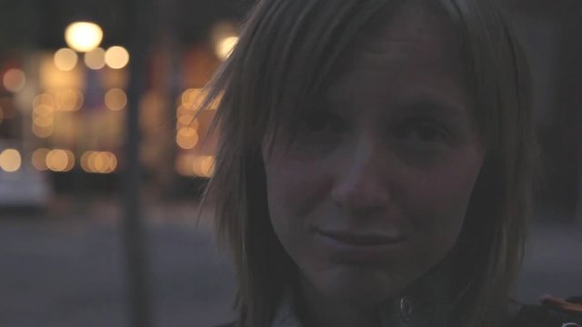 A sad young woman at night