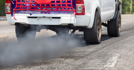 Air pollution from vehicle exhaust pipe on road