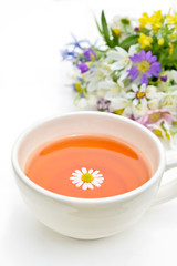 tea with chamomile and garden flowers