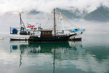 Fishing boats in the sea with mountains background