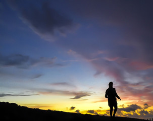 Girl at Sunset on a mountain ridge.