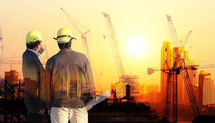 silhouette black man survey and civil engineer stand on ground working in a land building site over...