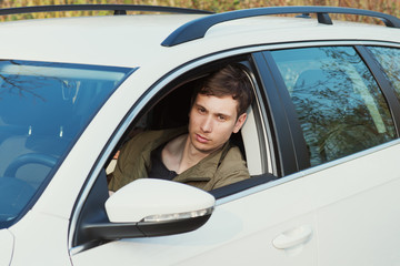 Handsome man in white car