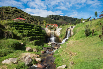 Artificial waterfall with blue sky in Cameron Highlands