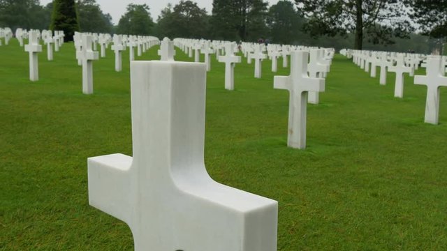 The view of the crosses aligned in the cemetery. This cemetery found in Normandy honors the American troops during the WWII