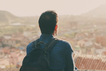 Tourist man looking on the city center during his trip in italy