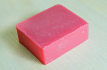 Soap bar flavor with strawberry ingredient isolated on wooden bo