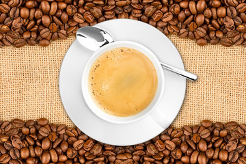 coffee cup background with beans  on burlap jute / Kaffeetasse mit Kaffeebohnen auf jute Sfoff