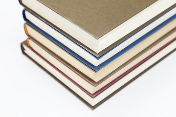 set of color books stacked on a white background
