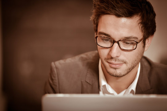 Portrait of smiling Businessman posing  in coworking office
