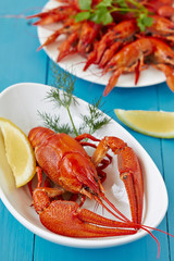 Fine crustacean for dinner. Boiled lobster and crayfish with lemon.