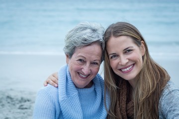 Smiling mother with daughter at beach