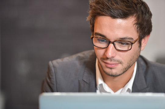 Portrait of smiling Businessman posing  in coworking office