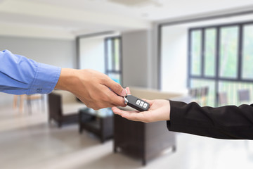 Buying Car. Businessman giving a key car to businesswoman