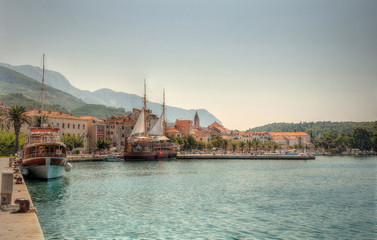 Obraz premium Der mediterane Hafen Makarskas (Kroatien) mit mehreren Ausflugsschiffen.The mediterranean port of Makarska (Croatia) with several excursion boats.