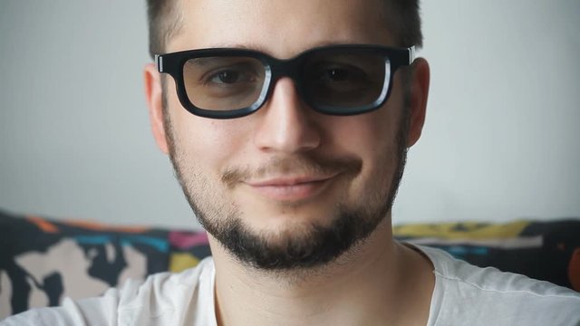 portrait of a man dressing 3D glasses and smiling