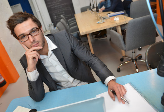 Portrait of smiling Businessman posing  in coworking office