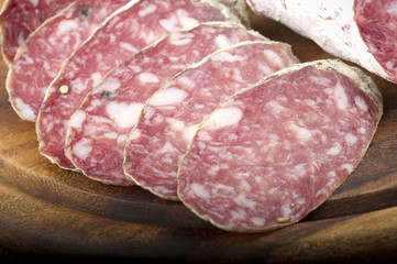 wooden cutting board with salami and bread