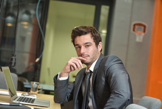 Portrait of smiling Businessman posing  in coworking office