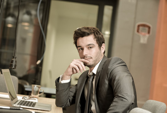 Portrait of smiling Businessman posing  in coworking office