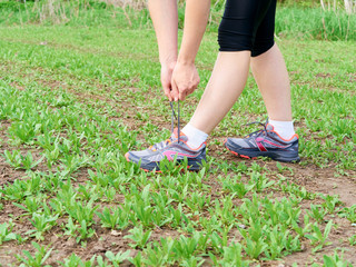  woman athlete tying running shoes.