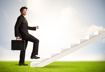 Fototapeta premium Business person climbing up on white staircase in nature