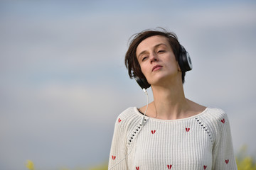 Young beautiful brunette woman girl listening music in headphone