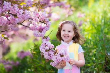 Fototapeta premium Little girl with cherry blossom