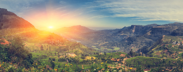 The sun sets behind the mountains. Beautiful view of the mountainous part of the island of Sri Lanka