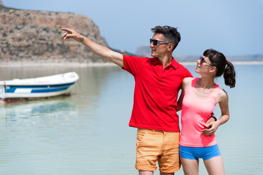 a lovely couple standing in the sea and hugging