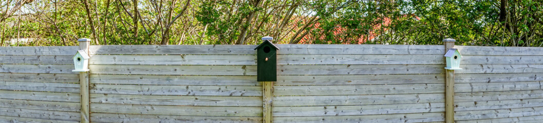 Bird houses on a row in a garden