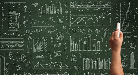 A business person drawing data on chalkboard